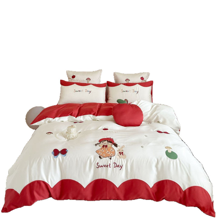 Bedding set with embroidered doll and apple motifs