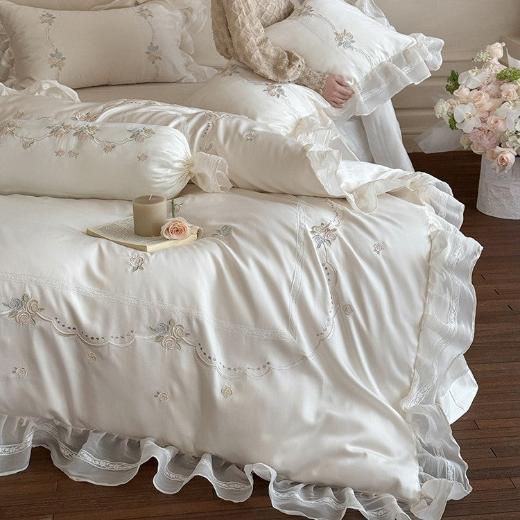 Satin bedding set with fine ruffle trim, delicate floral embroidery, and decorative pillowcases