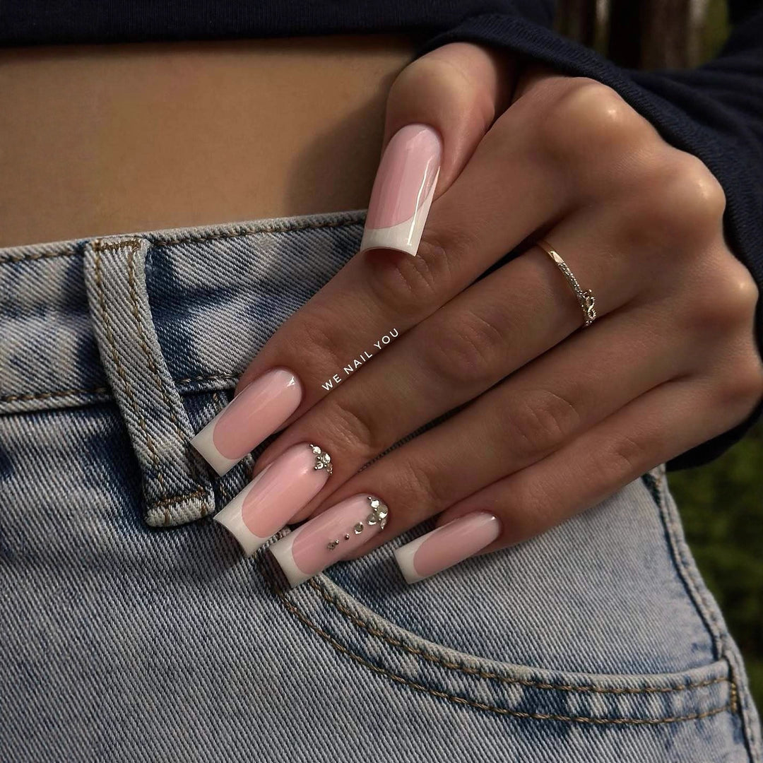 Acrylic nail set with elegant French tips and sparkling rhinestone accents Stornfield
