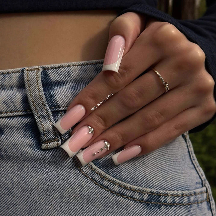 Acrylic nail set with elegant French tips and sparkling rhinestone accents Stornfield