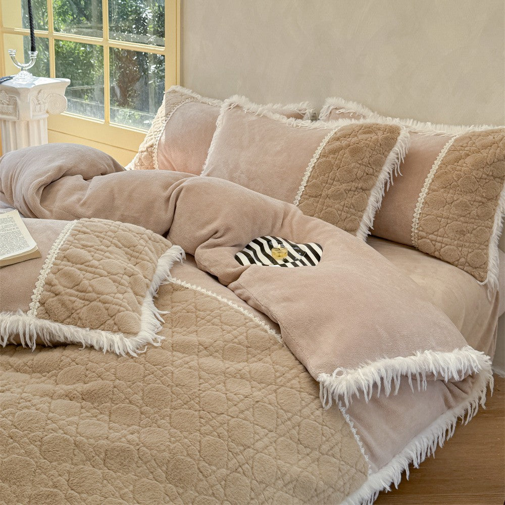 Quilted bedding with fringes and decorative pillows