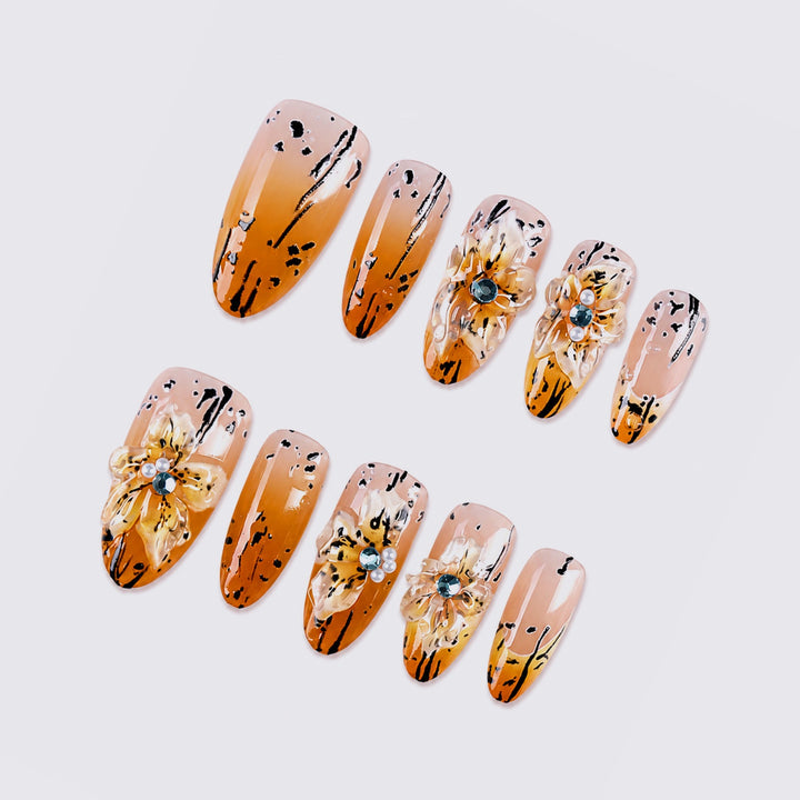 Artificial nail set with elegant floral design and sophisticated glitter elements Stornfield