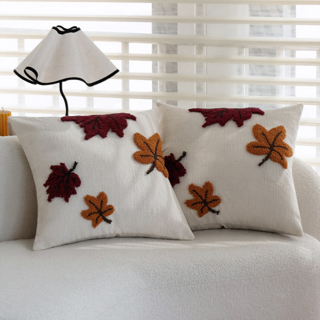Decorative cushion with embroidered leaf design