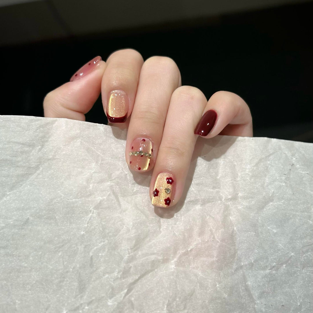 Artificial nails in luxurious glamour design with floral and glittering accents Stornfield