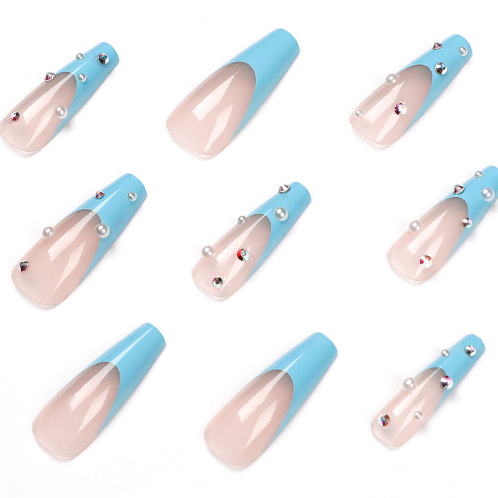 Artificial nail extensions with glitter and pearl accents Stornfield