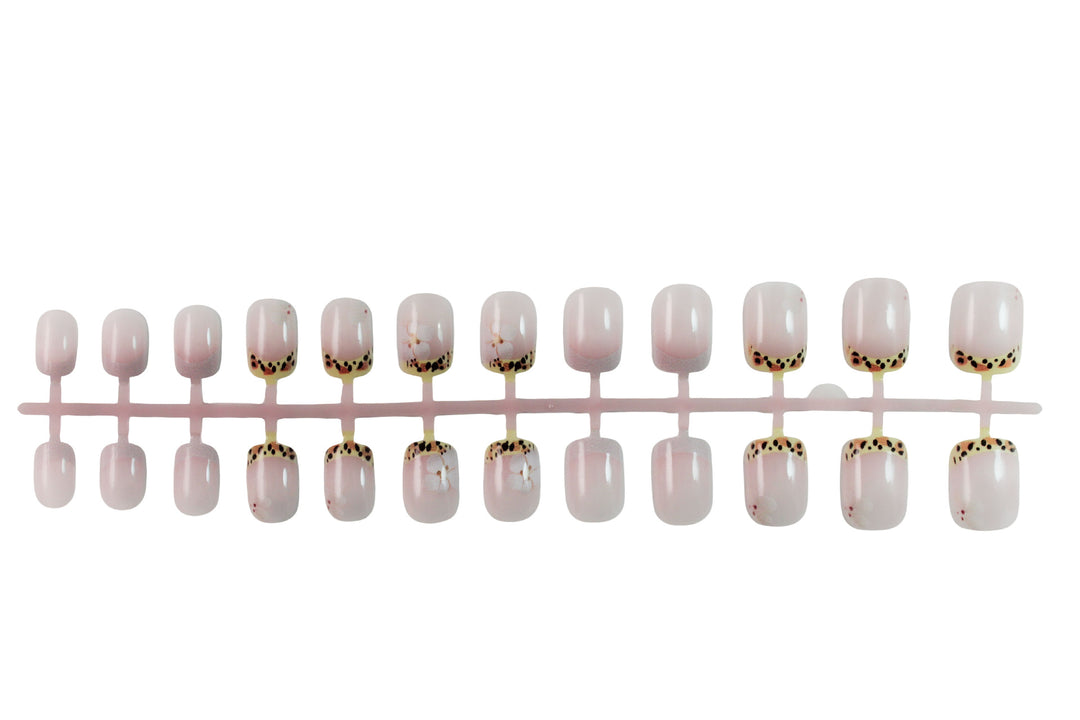 Artificial nail set with elegant French tip and floral accent Stornfield