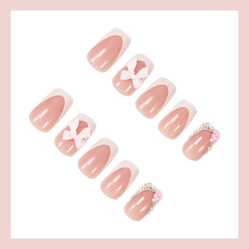 Artificial nail set with elegant bow and glitter designs Stornfield