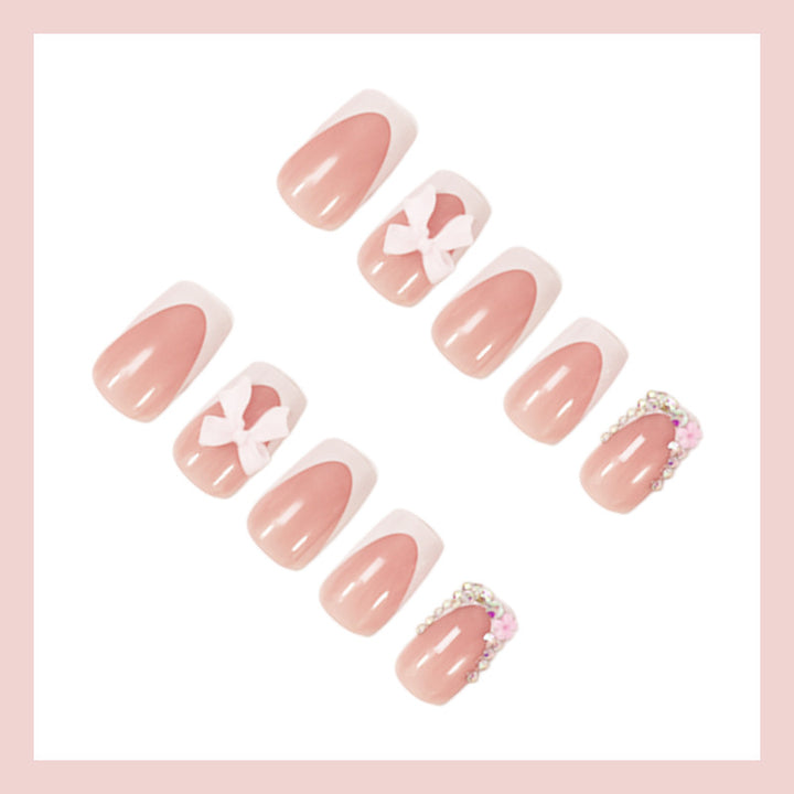 Artificial nail set with elegant bow and glitter designs Stornfield