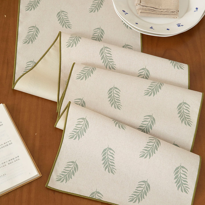 Woven table runner in botanical leaf pattern made of cotton blend Stornfield