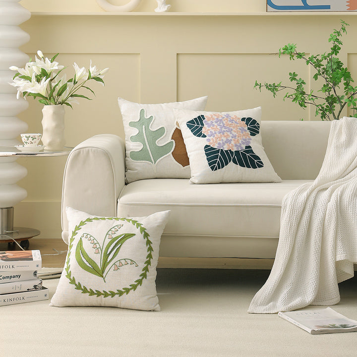 Square bouclé decorative cushion with tufted flower appliqué