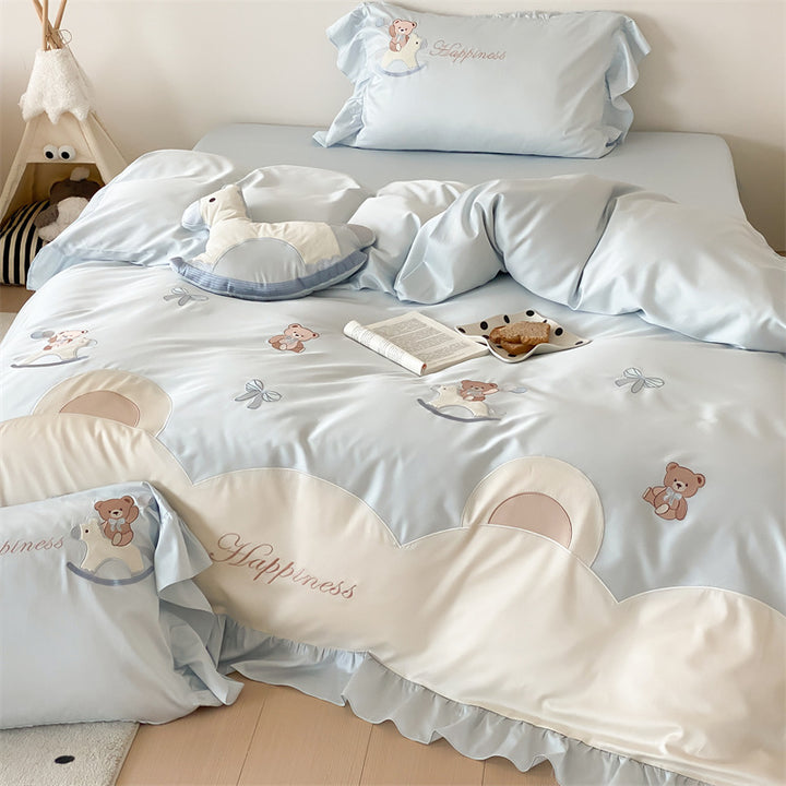 Playful satin bedding set with ruffled border, appliqués and quilted head section