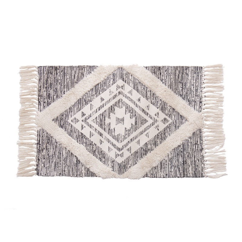 Hand-tufted cotton bath mat with botanical pattern and decorative fringes