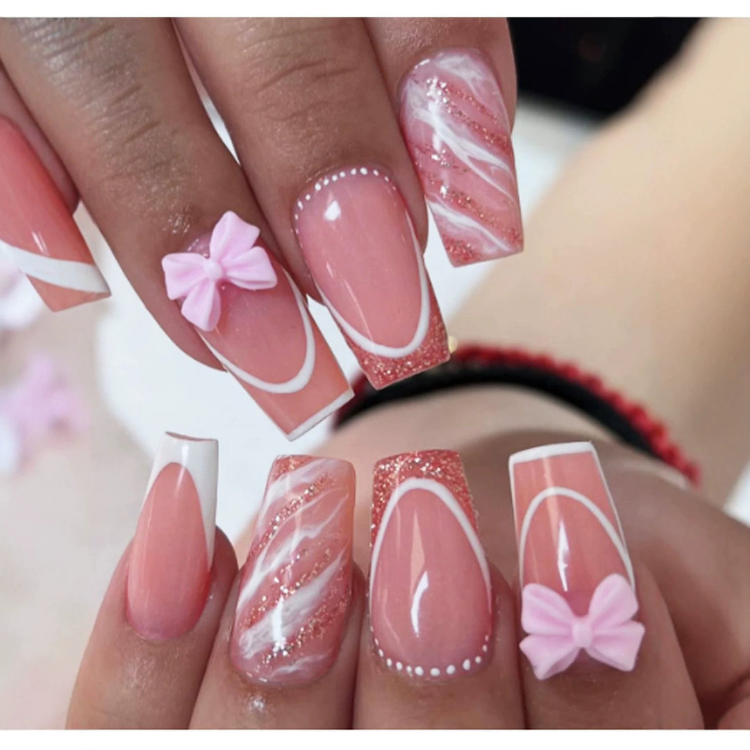 Acrylic nail set with elegant glitter design and playful bow accents Stornfield
