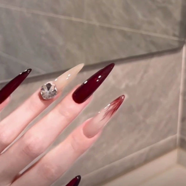Elegant Stiletto Nail Enhancements with Gem Accents Stornfield