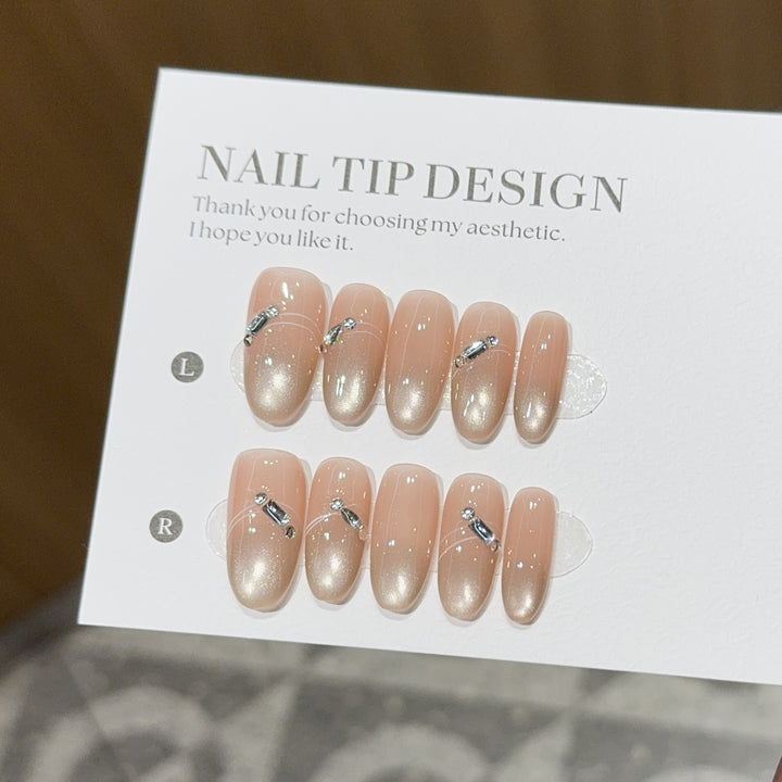 Artificial nail tips with elegant gradient color and rhinestone accents Stornfield