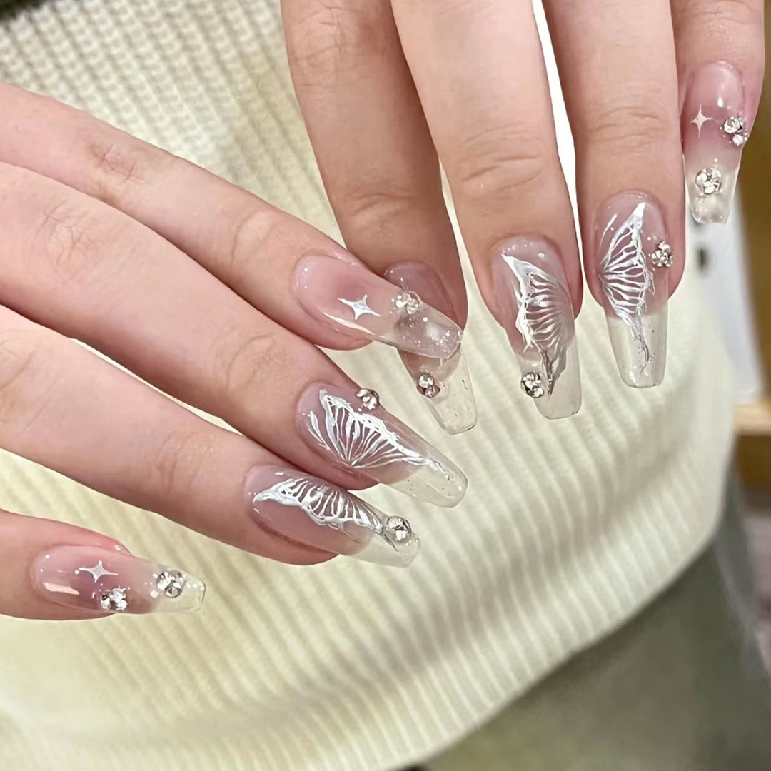 Elegant artificial nails with floral designs and glitter accents Stornfield