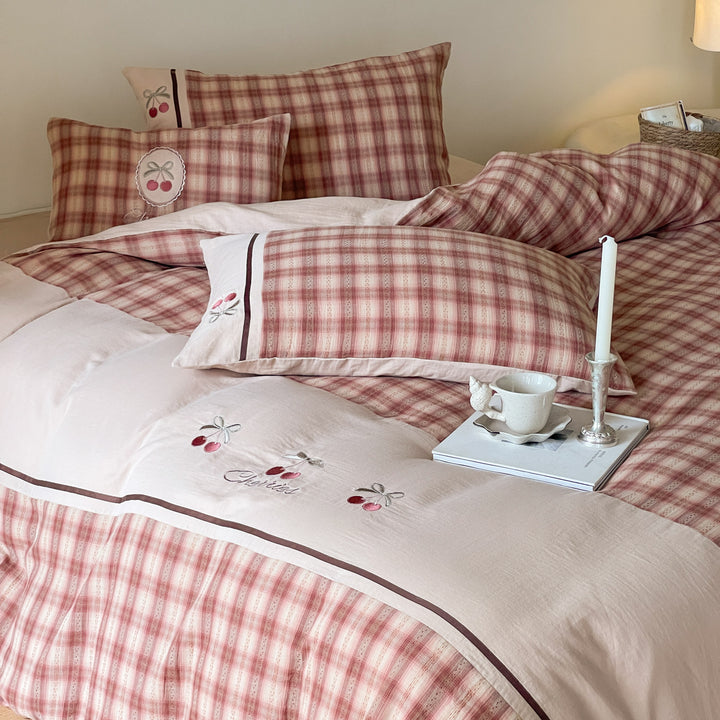 Luxurious cotton bedding set with check pattern and embroidered floral appliqués