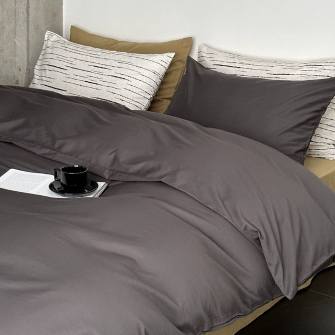 Modern satin bedding set with quilted look and patterned pillowcases