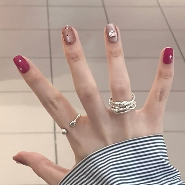 Artificial nail extensions with unique jewelry accents Stornfield