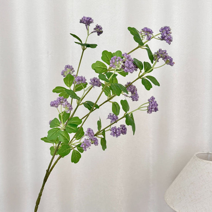 Artificial blossom branch with purple flowers