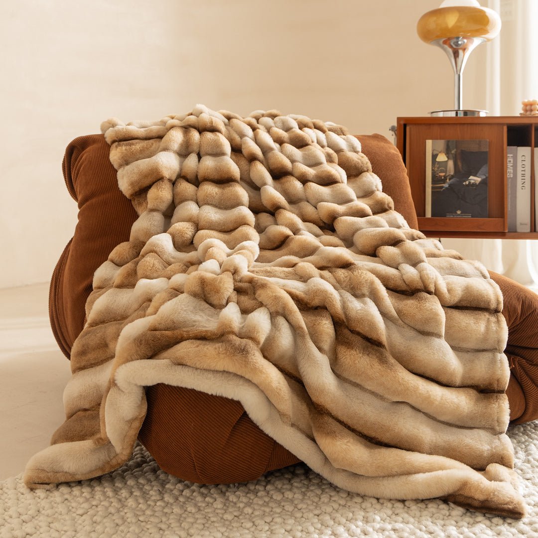 Luxurious faux fur throw blanket with relief-style quilting