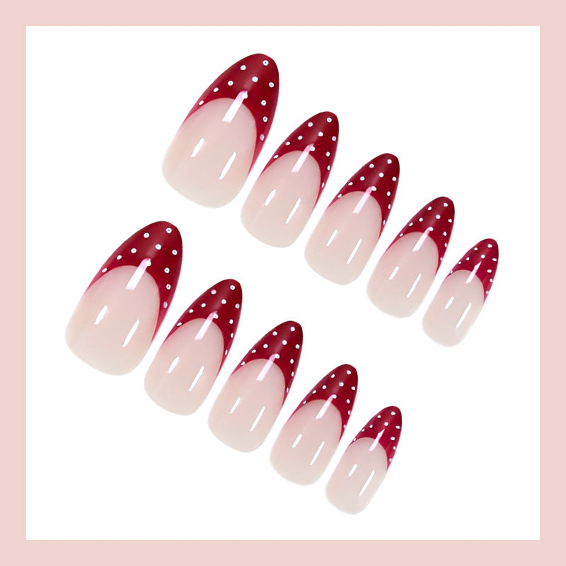 Nail art set with elegant red tips and playful dots Stornfield