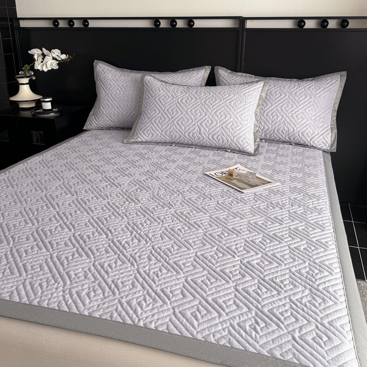 Quilted bedspread and pillow set with geometric striped quilting