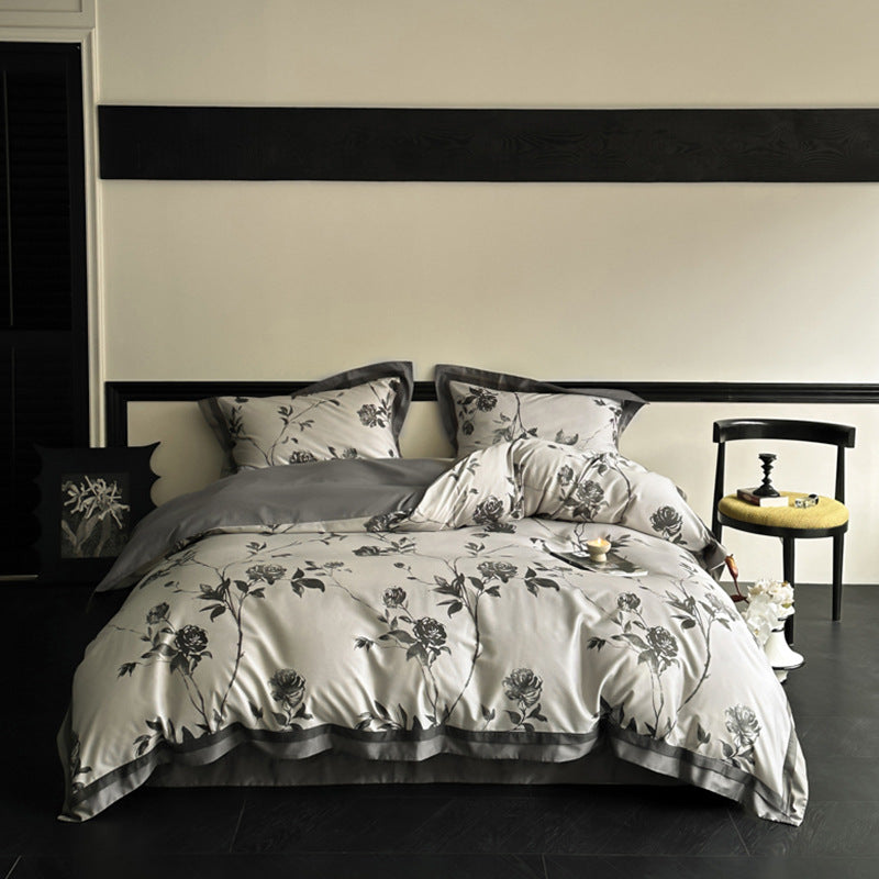 Reversible bedding set made of cotton satin with floral jacquard look and decorative hem