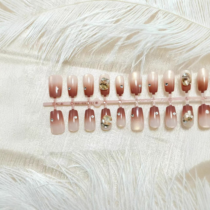 Artificials nails in elegant ombre style with rhinestone embellished applications Stornfield