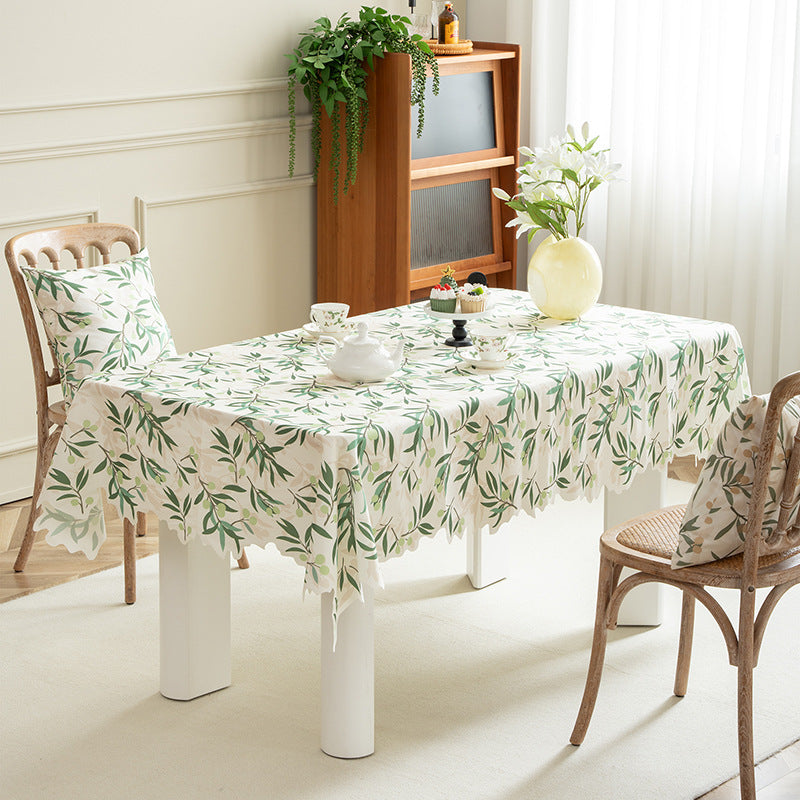 Round wipeable tablecloth with floral cut-out hem Stornfield
