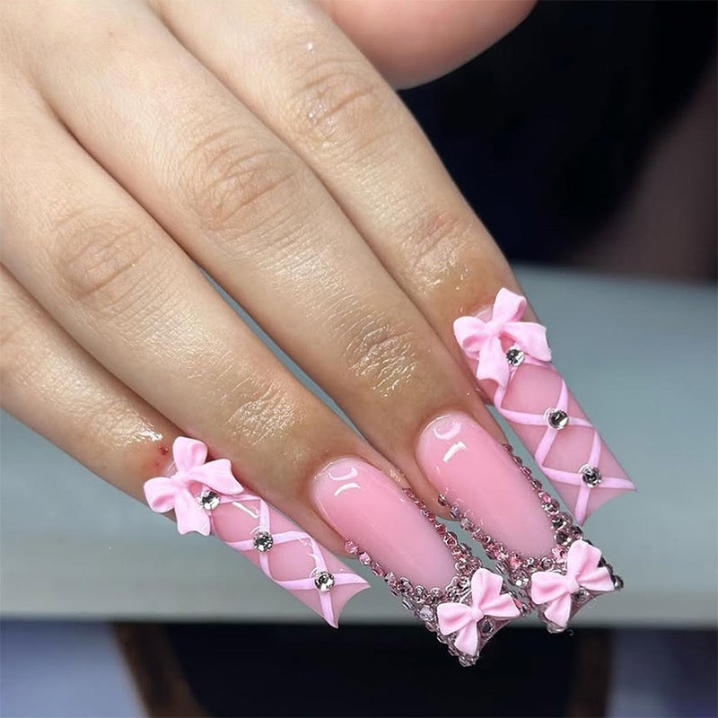 Artificial nail set with romantic bow and glitter accents Stornfield