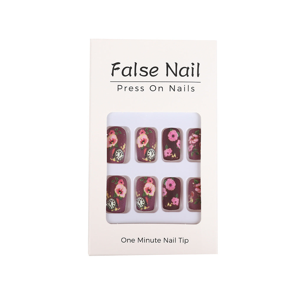 Nail art with floral design and intricate clock motifs Stornfield