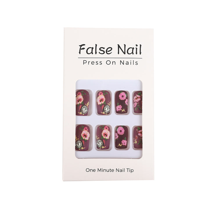 Nail art with floral design and intricate clock motifs Stornfield