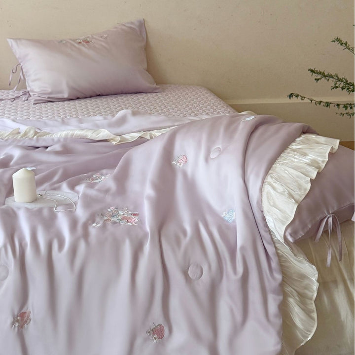 Romantic satin bedding set with ruffle, floral embroidery and tie pillow