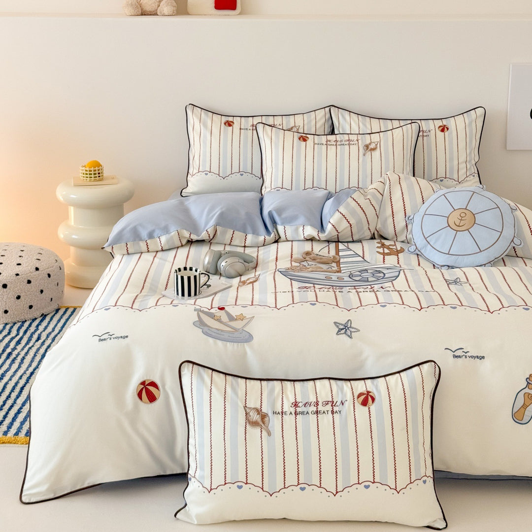 Children's bedding set with embroidered comic design and striped details