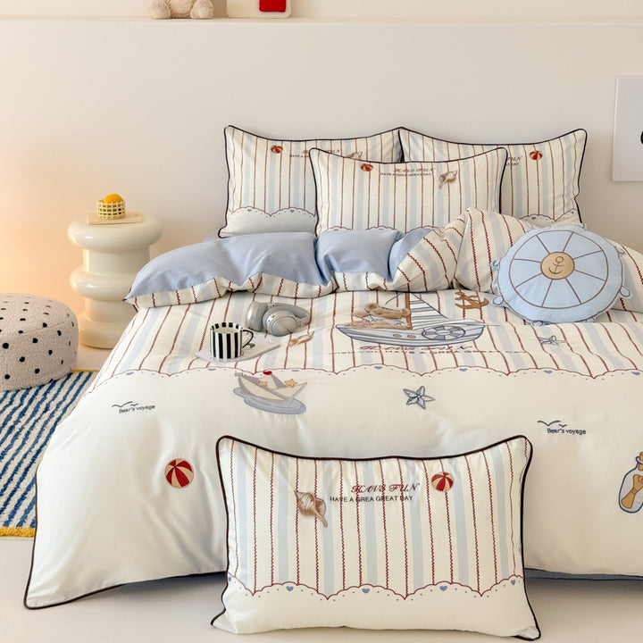 Children's bedding set with embroidered comic design and striped details