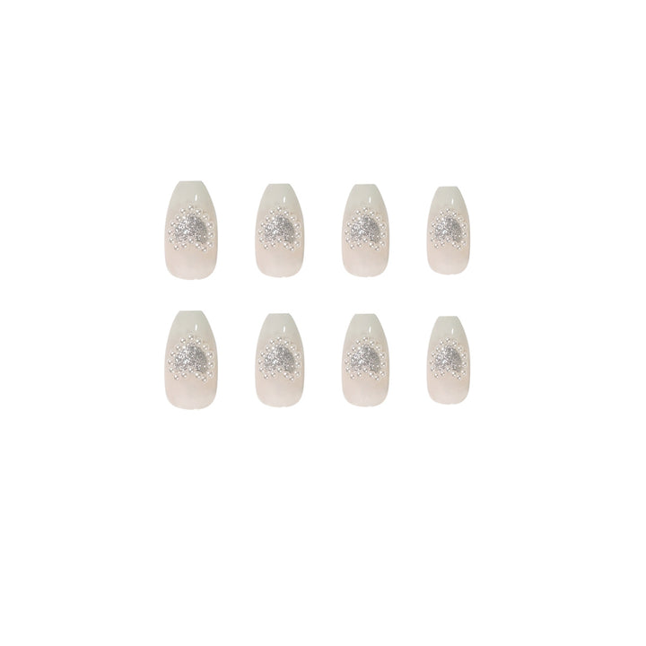 Artificial nail art with heart and rhinestone decorations Stornfield