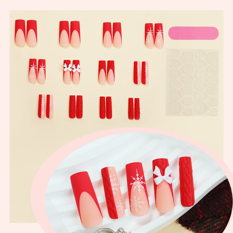 Artificial nail set with festive snowflake and bow motifs Stornfield
