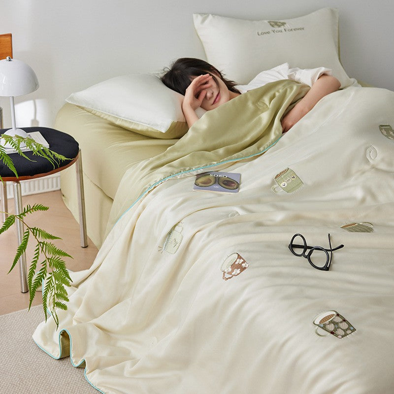 Luxurious satin bed linen set with embroidered Christmas tree motifs and contrasting piping