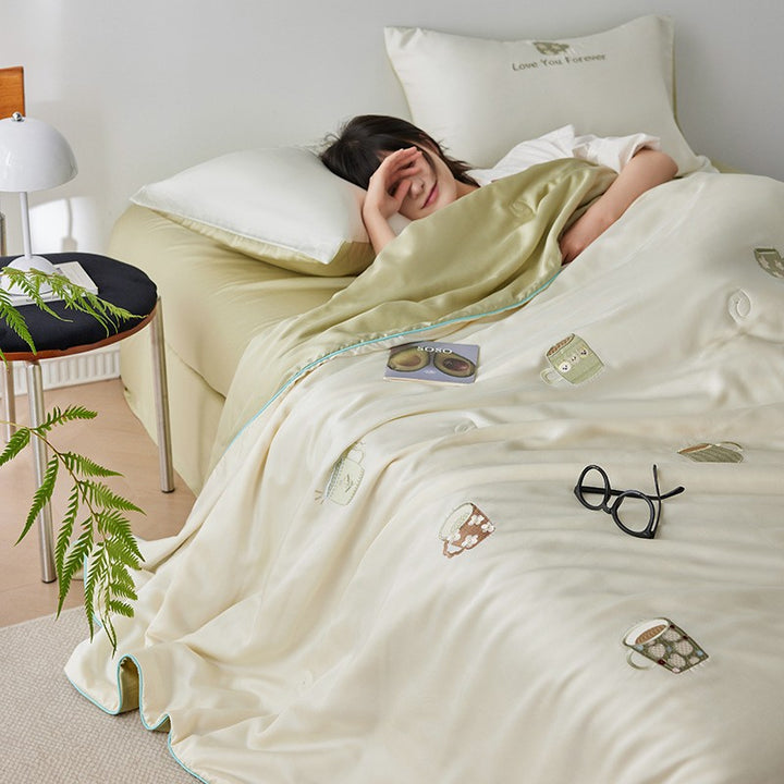 Luxurious satin bed linen set with embroidered Christmas tree motifs and contrasting piping