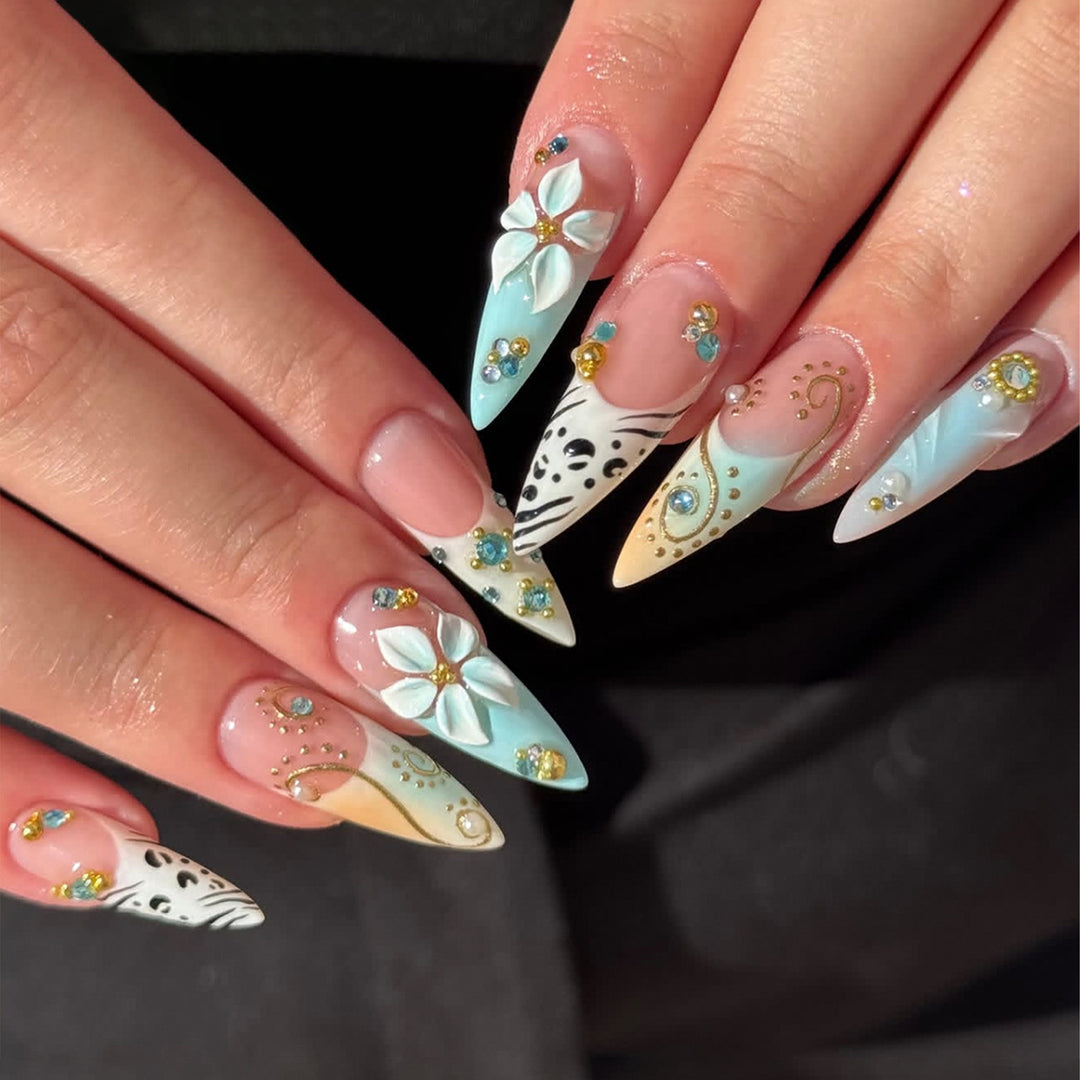 Artistic stiletto nails with floral accents and glitter details Stornfield