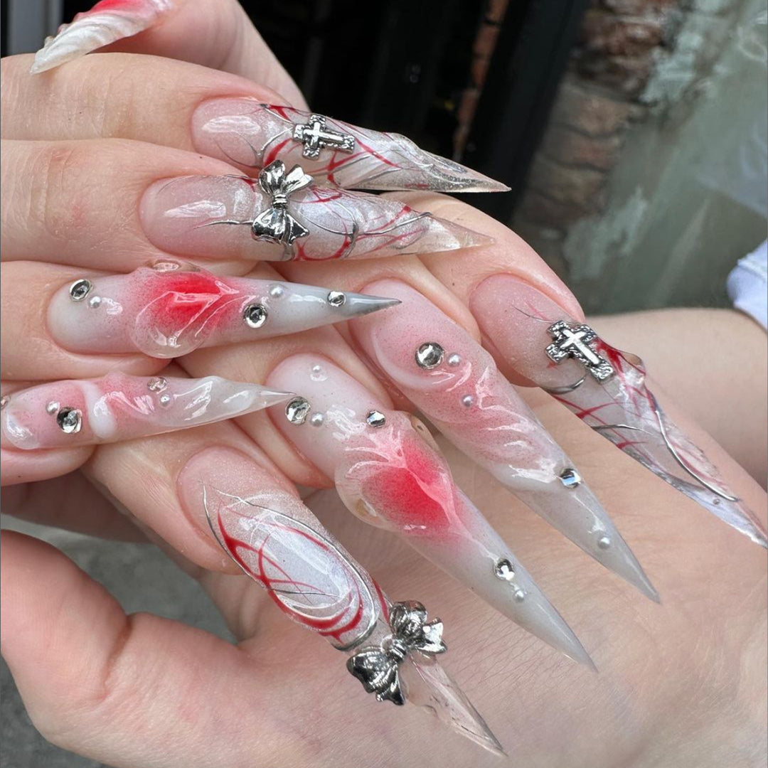 Artful stiletto nails with elegant floral accents and glitter embellishments Stornfield