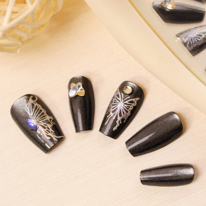 Artificial nails with decorative butterfly designs and glitter accents Stornfield