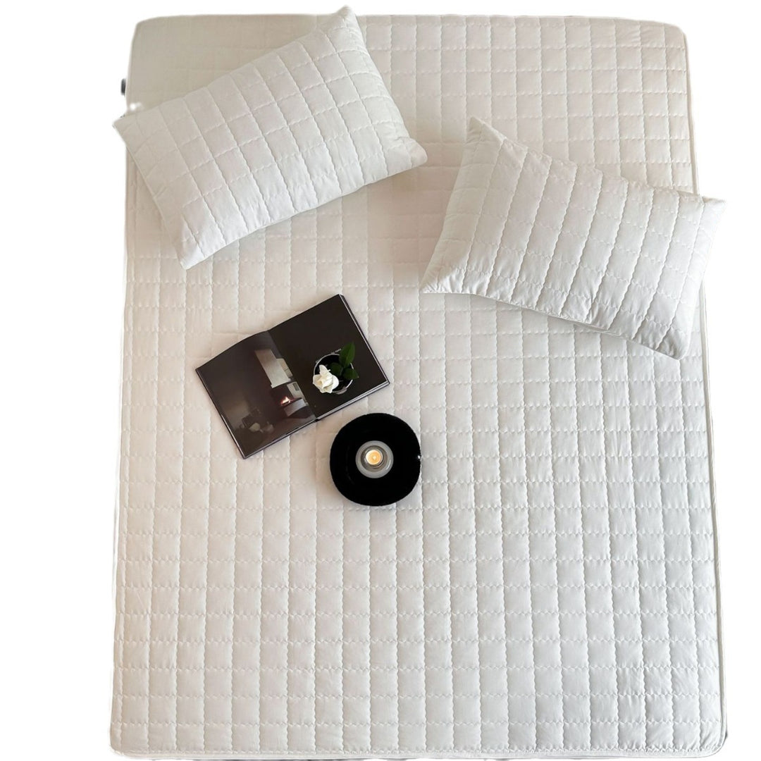 Padded quilted mattress topper with non-slip bottom and breathable fiber filling