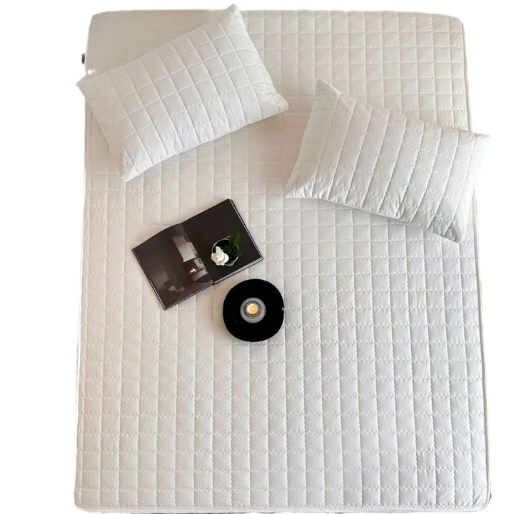 Padded quilted mattress topper with non-slip bottom and breathable fiber filling