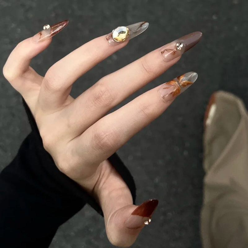 Artificial nails with elegant 3D details and sparkling accents Stornfield