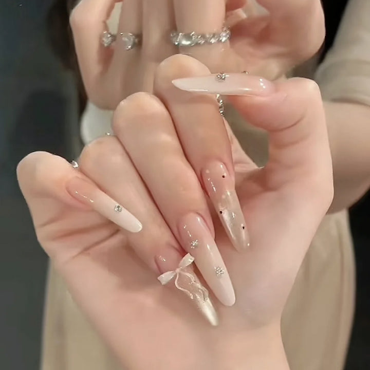 Artificial nails with elegant ombre effect and delicate rhinestone embellishments Stornfield