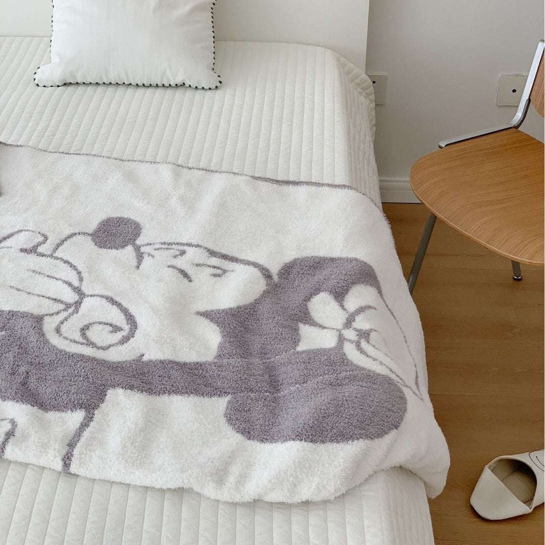 Cozy bedspread made of microfiber with a large woven cartoon motif