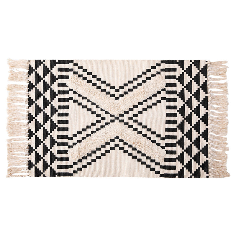 Hand-tufted bathroom mat with fringes, decorative dot-and-dash pattern and non-slip backing Stornfield