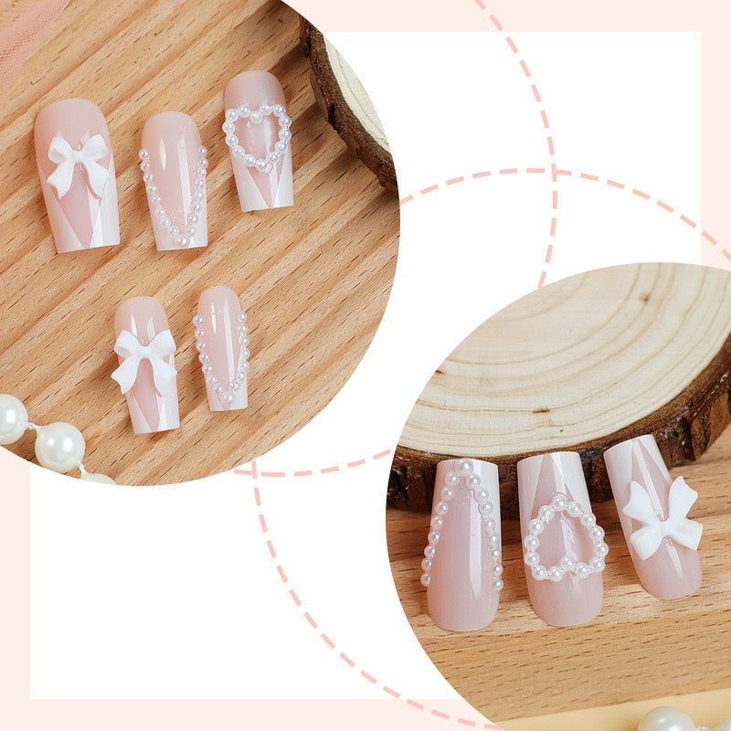 Artificial nail set with filigree hearts and bow decorations Stornfield